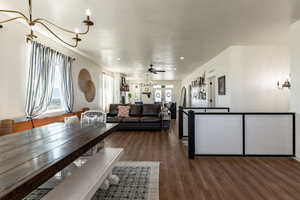 Interior space featuring ceiling fan and dark wood-type flooring