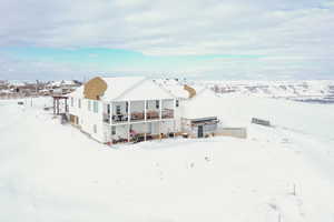 View of snow covered back of property