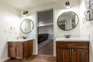 Bathroom with hardwood / wood-style floors and vanity