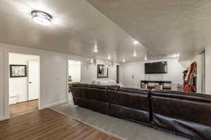 Living room featuring hardwood / wood-style floors and a textured ceiling