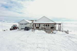 View of front of home featuring a porch and a garage