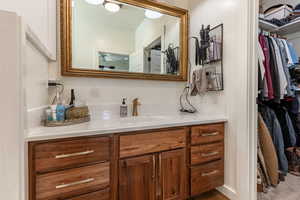 Bathroom featuring ceiling fan and vanity