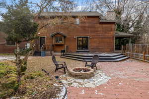 Back of house featuring a fire pit and a patio area