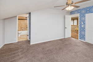 Interior space featuring carpet flooring, ceiling fan, a textured ceiling, and ensuite bath