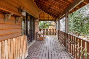 Wooden terrace featuring covered porch