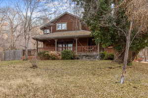 View of front of house featuring covered porch and a front lawn