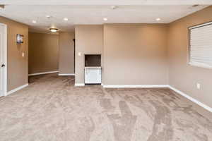 Carpeted spare room featuring a textured ceiling