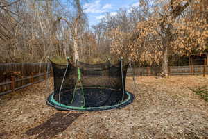 View of yard featuring a trampoline