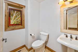 Bathroom with tile patterned floors, sink, and toilet