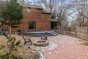 Exterior space with an outdoor fire pit and a patio