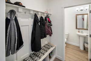 Mudroom featuring light hardwood / wood-style flooring and sink