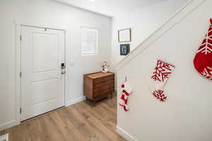 Entrance foyer with light wood-type flooring