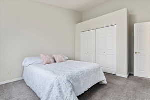 Bedroom with carpet flooring and a closet