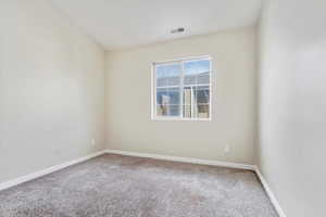 Spare room featuring carpet floors