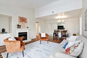 Living room with a notable chandelier and dark hardwood / wood-style floors