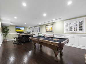 Game room with rail lighting, dark hardwood / wood-style floors, and pool table