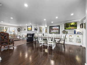 Dining space featuring hardwood / wood-style flooring and crown molding