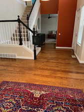 Foyer entrance with ceiling fan and hardwood / wood-style floors