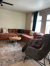 Living room with ceiling fan and carpet floors