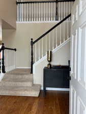 Stairway featuring hardwood / wood-style flooring