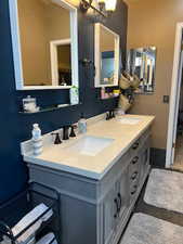 Bathroom with vanity and an inviting chandelier