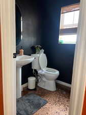 Bathroom featuring tile patterned flooring and toilet