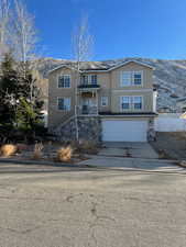 View of front of property featuring a mountain view and a garage