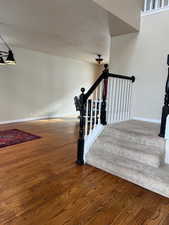 Staircase with hardwood / wood-style floors