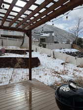 Snow covered deck with a pergola