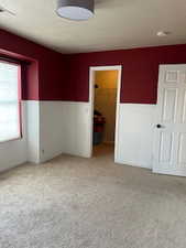 Unfurnished room featuring light carpet