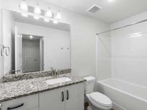 Full bathroom with vanity, toilet, and tub / shower combination