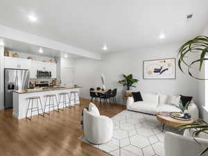 Living room with sink and light hardwood / wood-style flooring