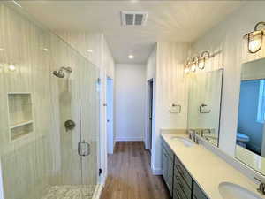 Bathroom featuring vanity, an enclosed shower, and hardwood / wood-style flooring