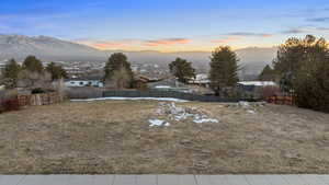 Yard at dusk featuring a mountain view