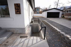 View of side of home with a garage and an outdoor structure