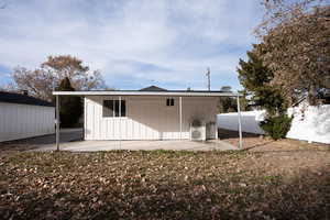 Back of house with ac unit and a patio