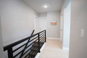 Corridor featuring a textured ceiling