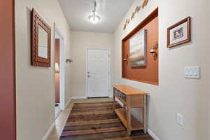 Entryway with tile floor and art nooks