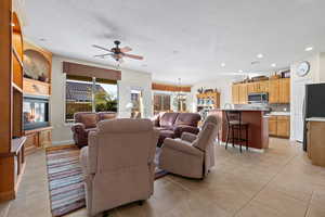 Spacious Living room with light large tile floors and beutiful buil ins