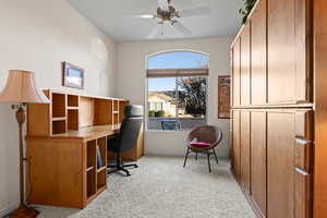 Carpeted home office with ceiling fan