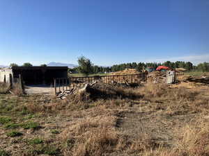 View of yard with a mountain view, a rural view, and an outdoor structure