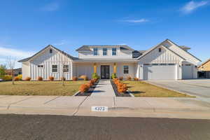 Modern farmhouse with a garage and a front lawn