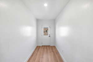 Hall with light hardwood / wood-style floors