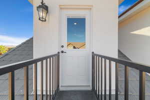 View of exterior entry with a balcony