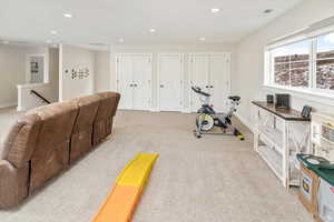 Exercise room featuring light colored carpet