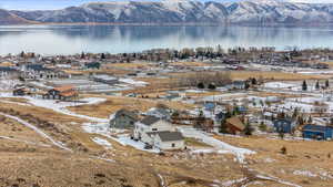 Birds eye view of property featuring a water and mountain view