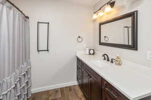 Bathroom featuring hardwood / wood-style floors and vanity