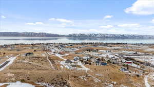 Birds eye view of property with a water and mountain view