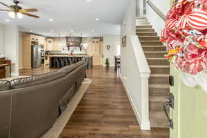 Living room featuring dark hardwood / wood-style floors and ceiling fan