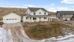 View of front facade with a porch and a garage